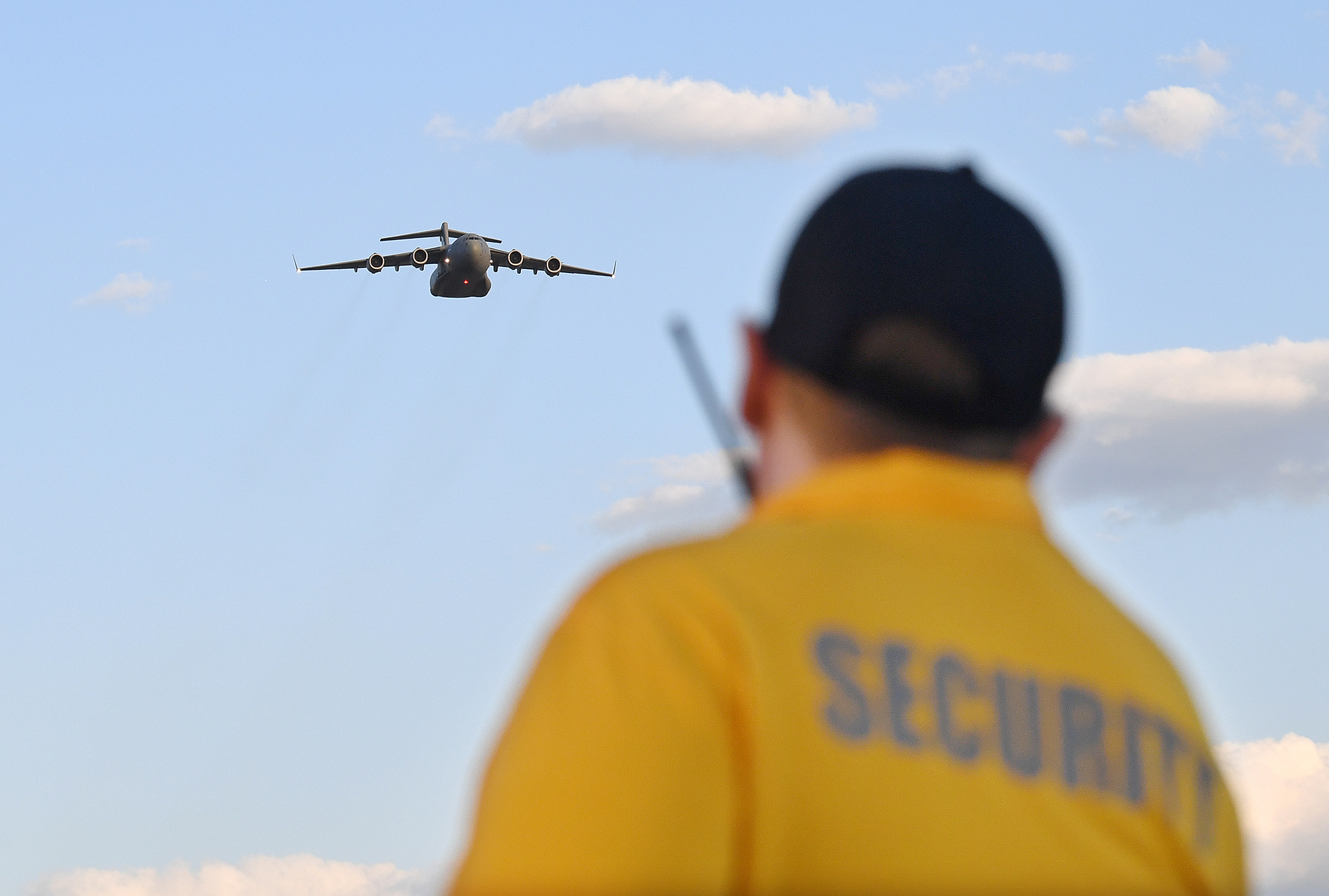 Security guard with plane in background