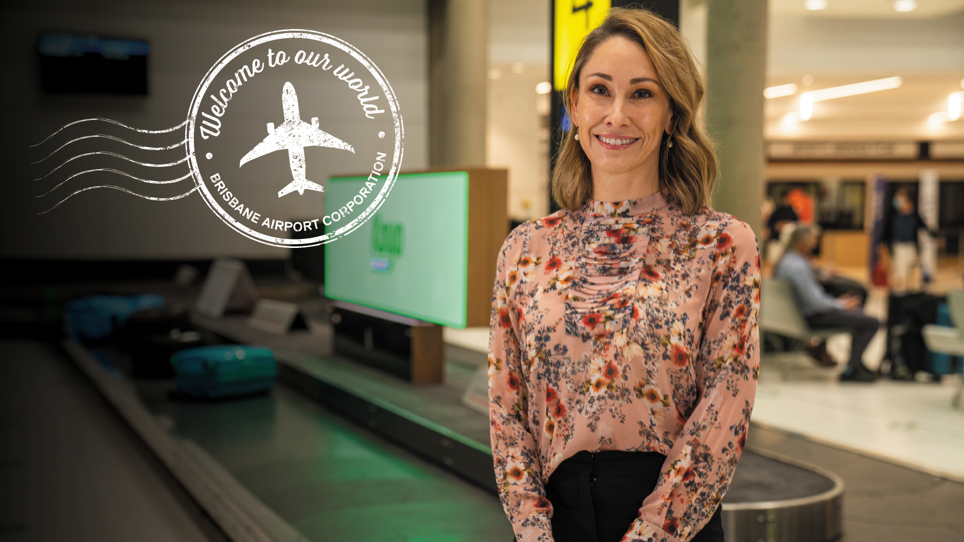 Woman at airport with &#039;Welcome to our World&#039; in writing